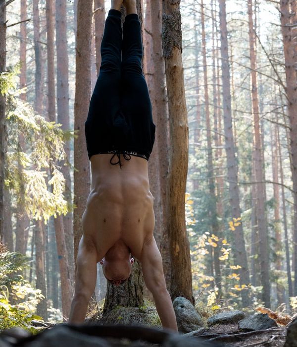 Man performing a controlled strength exercise in a calm environment.